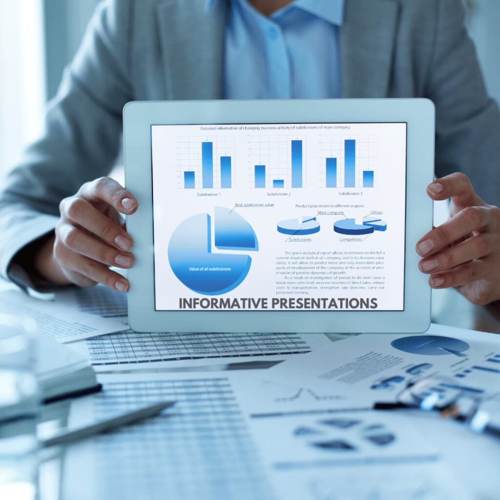 A person holding a tablet displaying various charts and graphs, with documents spread out on a table, representing informative PPT presentation creation services.