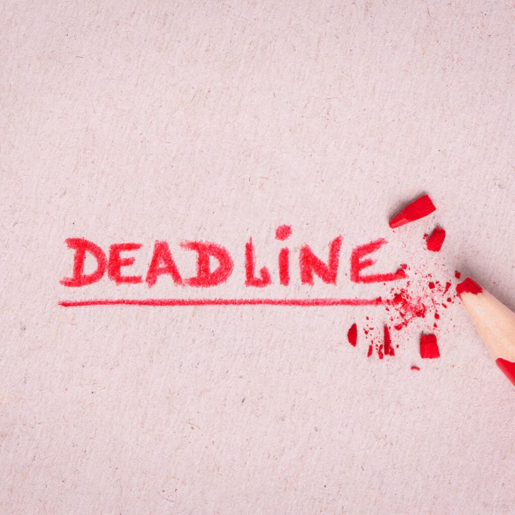 The word "DEADLINE" written in red pencil, with the pencil tip broken, emphasizing the importance of meeting deadlines in custom K12 content development services.