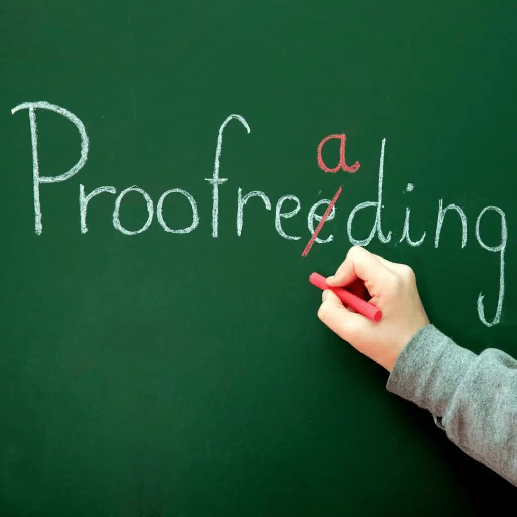 A hand correcting the spelling of "proofreeding" on a green chalkboard, representing professional proofreading services.